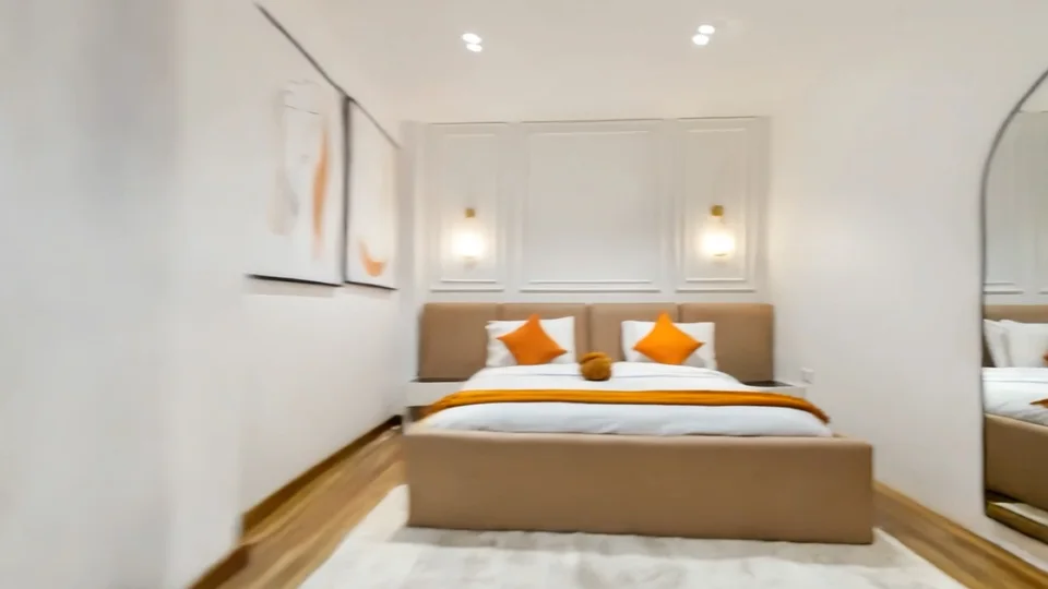 Bedroom with panelled wall and wall lights