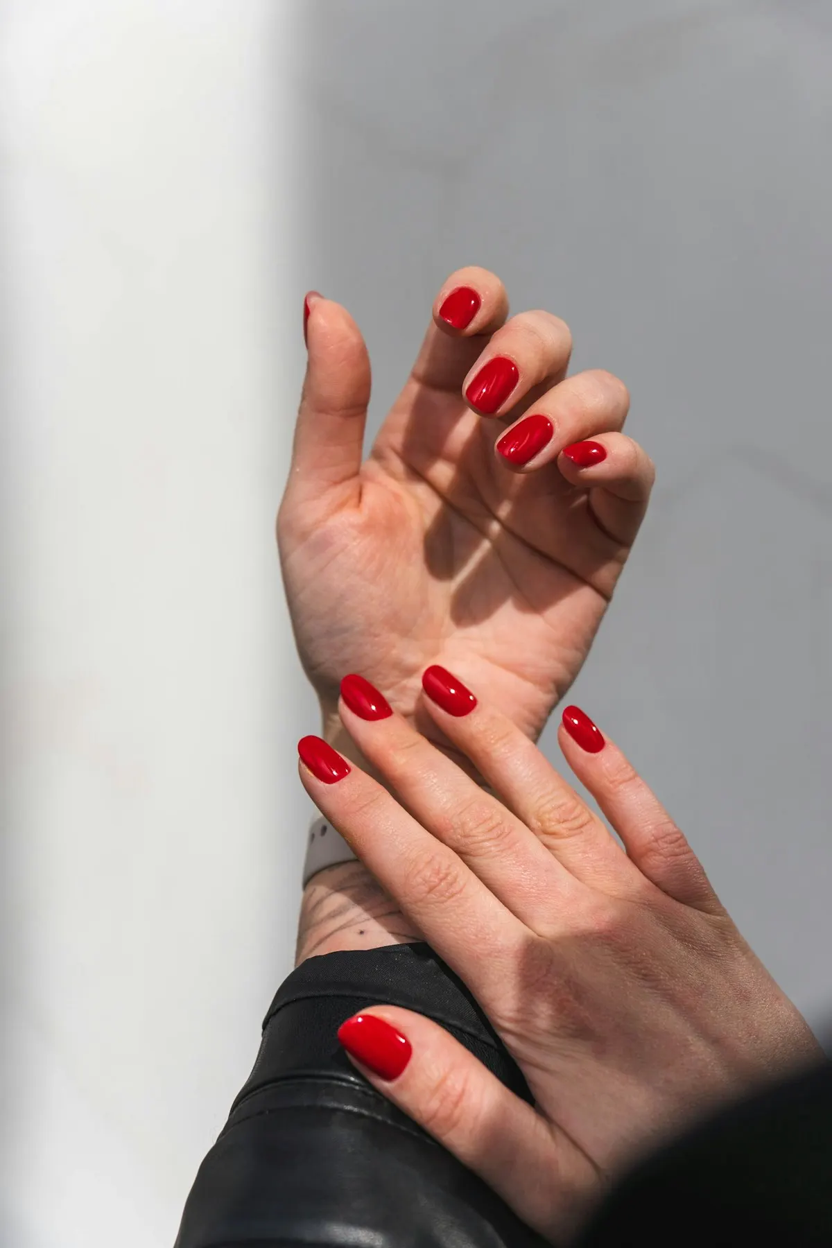 Hands with glossy red nails